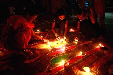 Devotees light oil lamps in a temple in Karachi