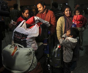 Indian family residing in Libya arrives at the airport in New Delhi