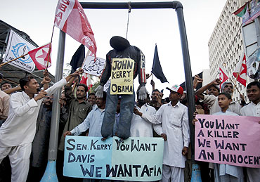 Pak protestors hang an effigy of US President Barack Obama and Senator John Kerry during a protest