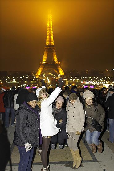 Revellers celebrate the New Year in front of the Eiffel tower in Paris