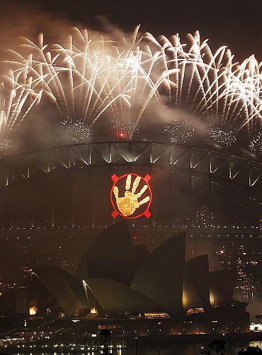 Fireworks explode over the Sydney Harbour Bridge and Opera House during a pyrotechnic show to celebrate the New Year