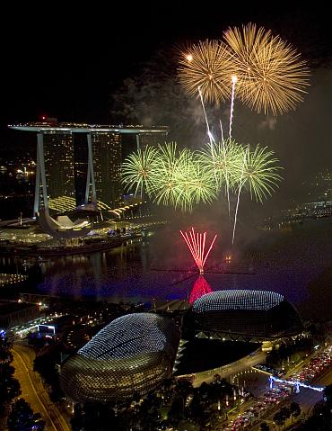 Fireworks explode over Marina Bay in front of the Marina Bay Sands casino and resort during a pyrotechnic show to welcome the new year in Singapore