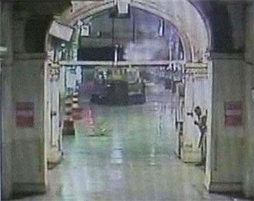 A Mumbai policeman takes cover behind a wall during a gunbattle with terrorists at the Chhatrapati Shivaji Terminus in Mumbai November 26, 2008 in this video grab from the station's CCTV footage