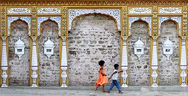 Pakistani children play outside an old Hindu temple