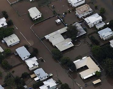 Buildings are submerged in floodwaters in a neighborhood in Rockhampton, Queensland
