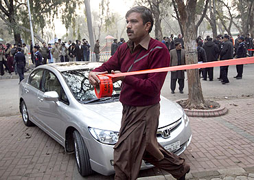 A policeman cordons off the site where Salman Taseer was shot dead in Islamabad