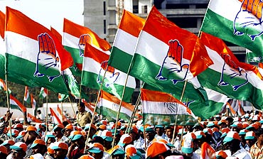 Supporters hold party flags during a Congress election campaign rally in Mumbai