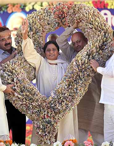 Uttar Pradesh Chief Minister Mayawati receives a garland made-of currency notes by her party supporters during a party workers meeting in Lucknow
