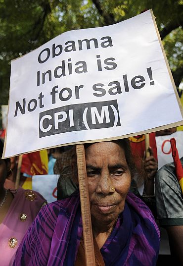 A CPI-M supporter holds a placard during a protest against US President Barack Obama's visit to India, in New Delhi