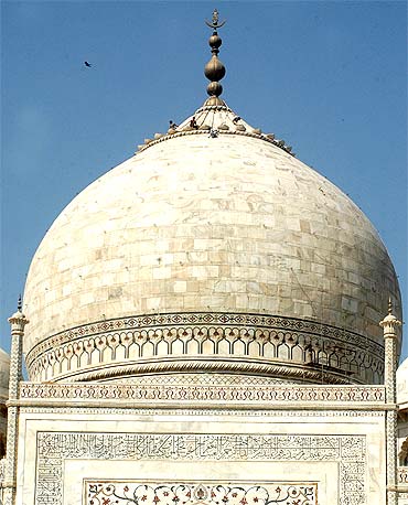 Workers repair a dome of the Taj Mahal