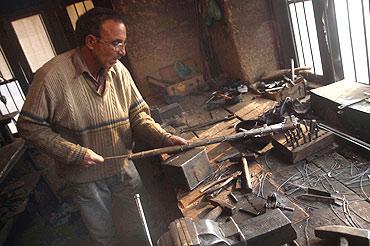 Zahoor fashions a gun at his factory