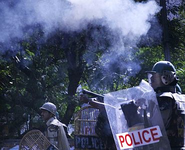 Policemen fire teargas shells at protestors