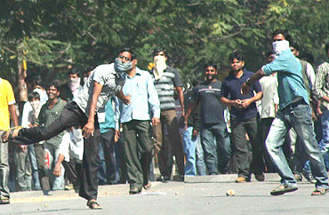 Pro-Telangana students of Osmania university hurl stones at security forces in Hyderabad on Friday
