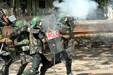 Policemen clash with protesting students at the campus on Friday