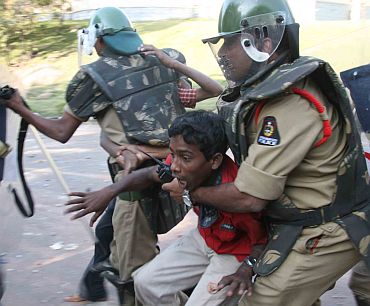 A student protestors being detained by policemen