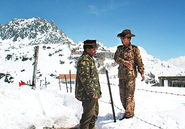 An Indian army officer talks with a Chinese soldier at Nathu-la