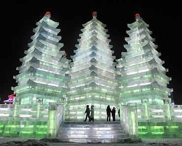 People visit tall ice pagodas