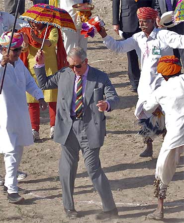 Britain's Prince Charles dances with villagers at Tolasar village near Jodhpur