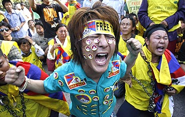 Tibetan exiles shout slogans during a protest outside the United Nations headquarters in New Delhi