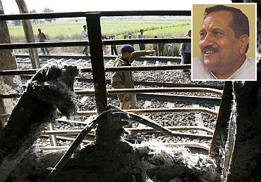 Inset: Indresh Kumar. Onlookers stand near a burnt carriage of Samjhauta Express train.