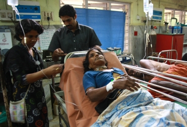 A devotee who was injured after the stampede rests inside a hospital at Kottayam in Kerala