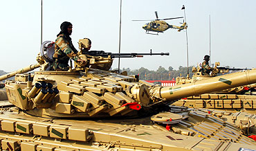 Soldiers mounted on army tanks take part in the Army Day parade in New Delhi