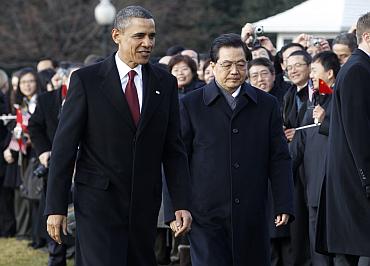 US President Barack Obama and Chinese President Hu Jintao walk past guests at the South Lawn