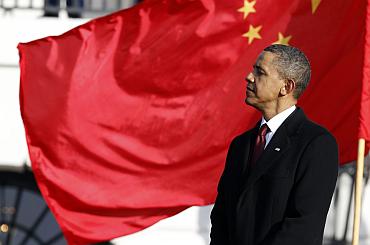 US President Barack Obama listens as Chinese President Hu Jintao speaks at the South Lawn
