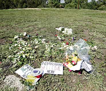 Flowers and candles from a vigil are seen at the park where Nitin Garg of India was stabbed in the western suburbs of Melbourne