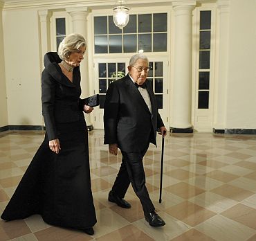 Former US Secretary of State Henry Kissinger arrives with his wife Nancy for the state dinner