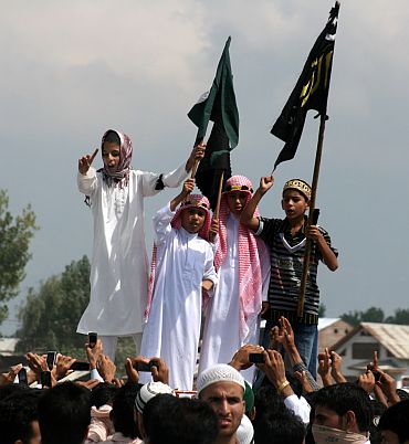 Children chant pro-freedom slogans during an anti-India procession in Srinagar