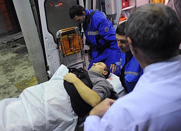 Medics wheel a victim of the bomb explosion at Domodedovo airport from an emergency vehicle into the N v Sklifosovsky Scientific Research Institute of First Aid in Moscow