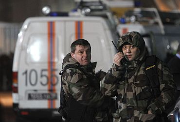 Members of the Federal Security Service work outside Moscow's Domodedovo airport following the blast