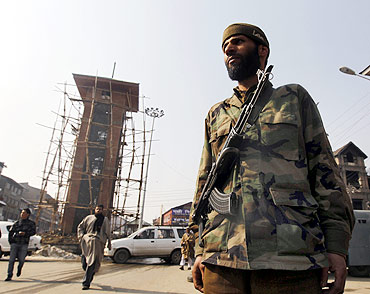 A policeman stands guard in front of Kashmir's clock tower at the historic Lal Chowk