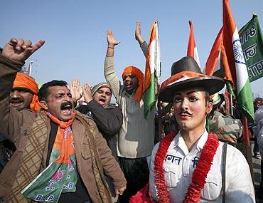 BJP supporters shout slogans next to a model of freedom fighter Bhagat Singh in Madhopur, Punjab