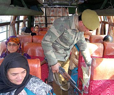Security personnel conducting a search op in a bus