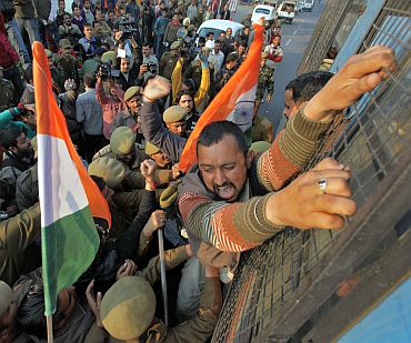 A BJP supporter shouts as he is detained by police during a protest near Jammu airport