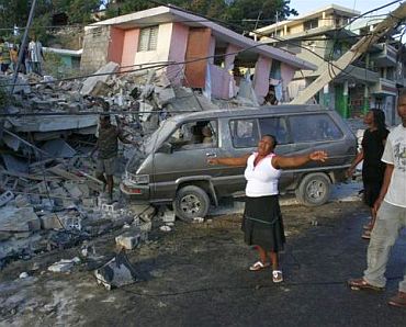 A woman reacts near destroyed buildings after an earthquake in Port-au-Prince, Haiti, January 13, 2010