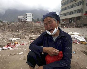 A 70-year-old woman cries for her relatives who died during a mudslide in Zhouqu of Gannan Tibetan Autonomous Prefecture, Gansu Province, China, August 17, 2010