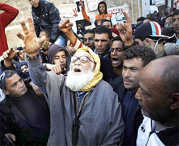 A man takes part in a demonstration in front of the prime minister's office in Tunis
