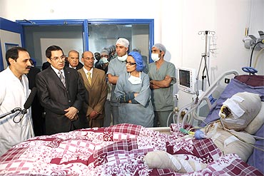 Tunisian President Zine El-Abidine Ben Ali visits Mohamed Al Bouazzizi, the protester who set himself alight during a demonstration against unemployment, at a hospital in Ben Arous near Tunis. Bouazizi, a vegetable seller, set himself alight on December 17 and died on January 5, 2011, igniting nationwide protests that forced ex-president Zine al-Abdine Ben Ali to flee the country
