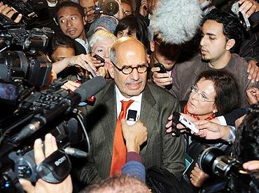 Egyptian reformed campaigner Mohamed ElBaradei talks to journalists outside Cairo's airport