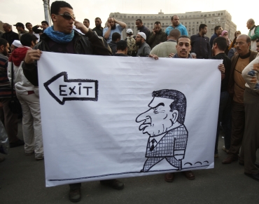 Protesters hold a banner against President Hosni Mubarak during a demonstration in Cairo