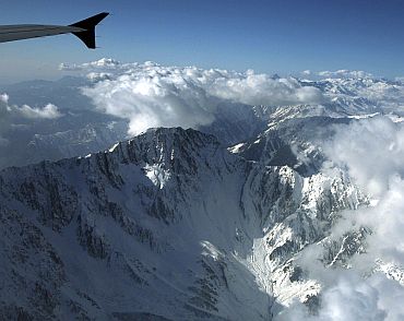 The snow-covered Pir Panjal mountain range in Kashmir is seen from the window of a passenger airplane January 9, 2011