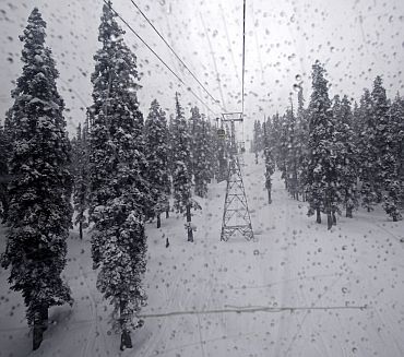 A picture taken from inside the cabin of a gondola shows the snow-covered trees in Gulmarg, 55km west of Srinagar