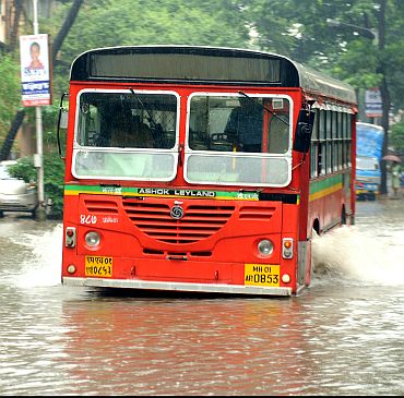 A BEST bus makes its way through a flooded street at Sion