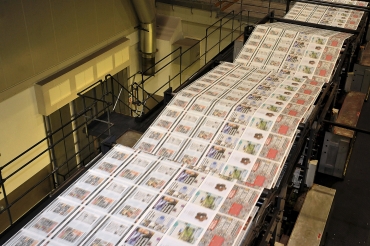Copies of the final edition of the News of the World are printed on the presses at the News International print works in Waltham Cross, southern England