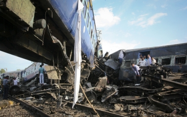 People search through the mangled carriages of Kalka Mail