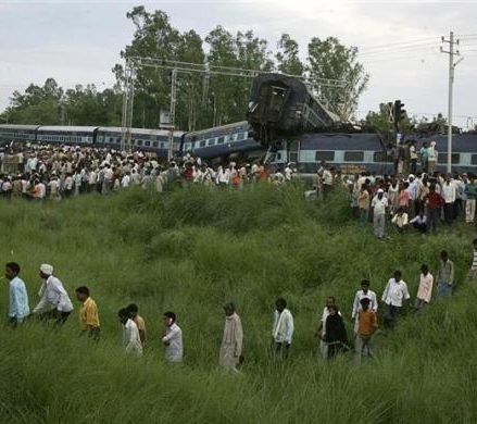 People search the mangled carriages of the Kalka Mail train which derailed near Fatehpur