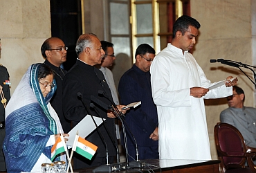 Patil administers the oath as Minister of State to Milind Deora